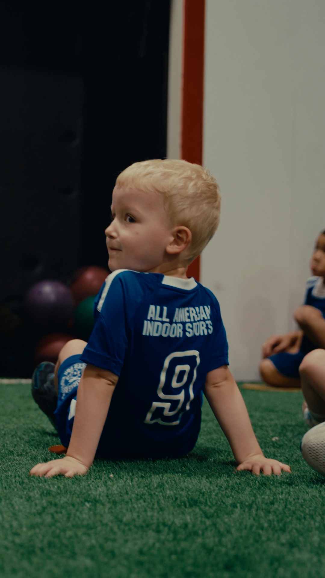 Young children playing soccer